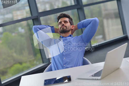 Image of happy young business man at office