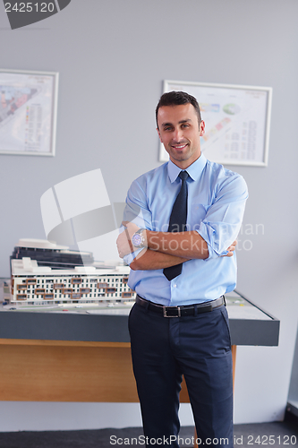 Image of happy young business man at office