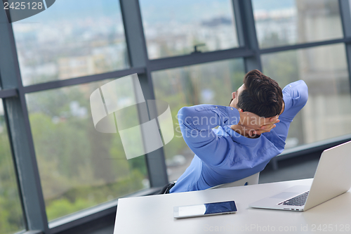 Image of happy young business man at office