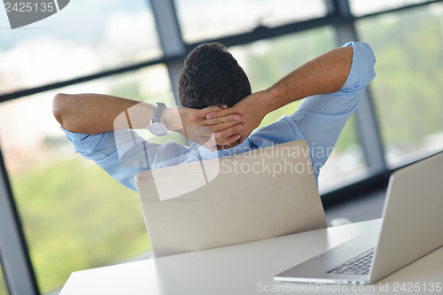Image of happy young business man at office