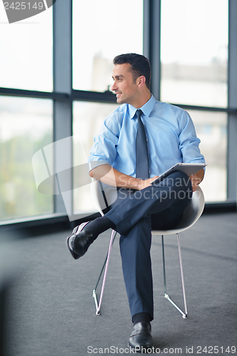 Image of happy young business man at office