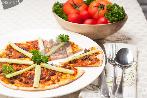 Image of Turkish beef pizza with cucumber on top