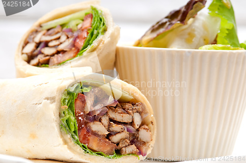 Image of kafta shawarma chicken pita wrap roll sandwich