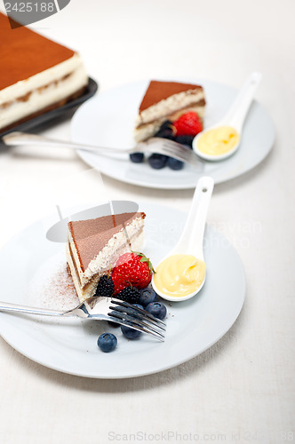 Image of tiramisu dessert with berries and cream