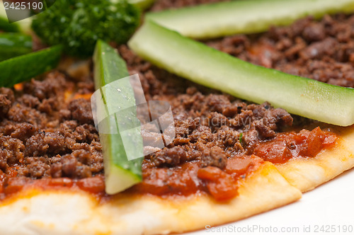 Image of Turkish beef pizza with cucumber on top