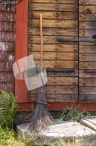 Image of Broom at the entrance of a rustic house