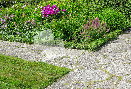 Image of Stone paths in a flowering garden