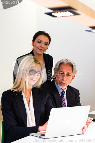 Image of Group in business meeting with laptop
