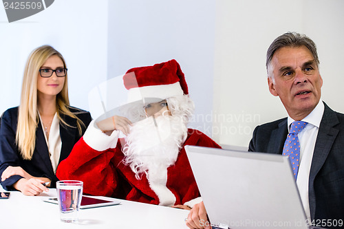 Image of Santa Claus in business meeting