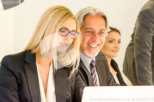 Image of Group in business meeting with laptop