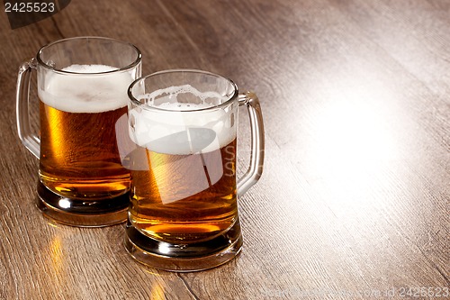 Image of Two glass beer on wooden table