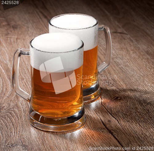 Image of Two glass beer on wooden table