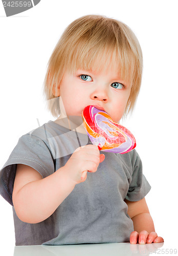 Image of Baby eating a sticky lollipop