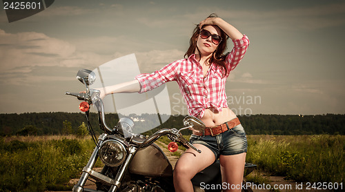 Image of Biker girl and motorcycle