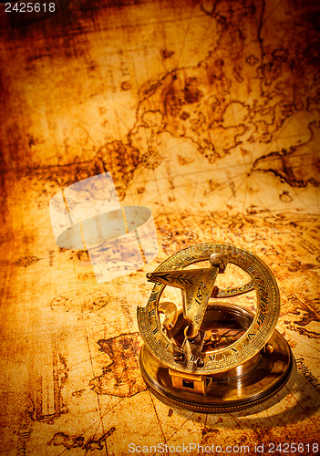 Image of Vintage compass lies on an ancient world map.