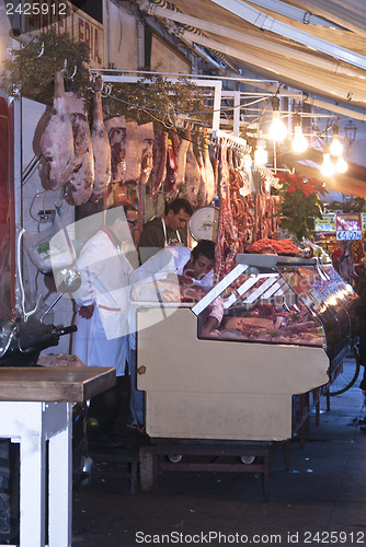 Image of butcher sells meat on the local market in Palermo