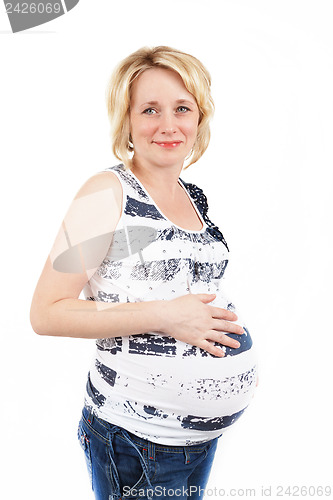 Image of beautiful pregnant woman tenderly holding her tummy isolated on white background