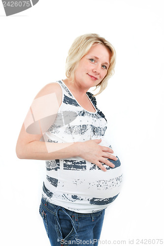 Image of beautiful pregnant woman tenderly holding her tummy isolated on white background