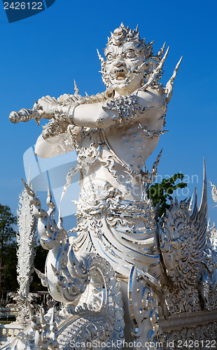 Image of sculpture soldier guards the entrance to the white temple in Chi