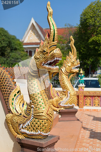 Image of Thai golden dragon guards the entrance to the temple