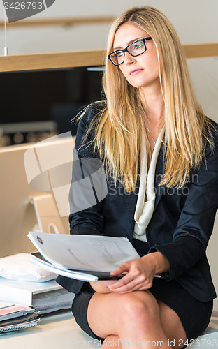 Image of Businesswoman In Office Working On A Document