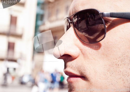 Image of portrait of a attractive gorgeous guy wearing sunglasses