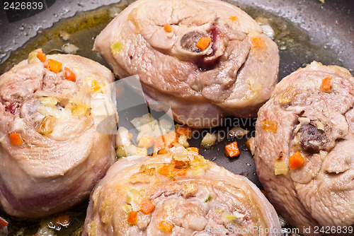 Image of veal shank cooking in pan