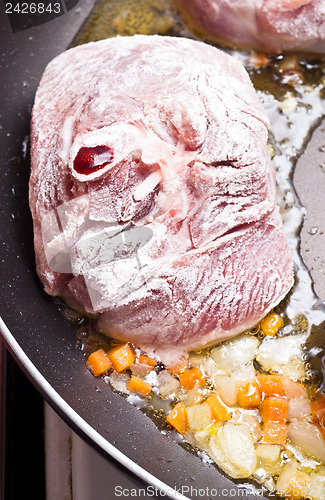 Image of floured osso buco in pan