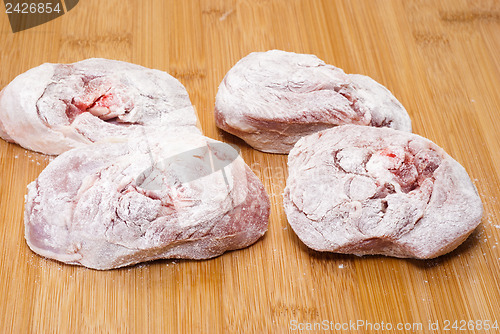 Image of ossobuco floury on wooden board