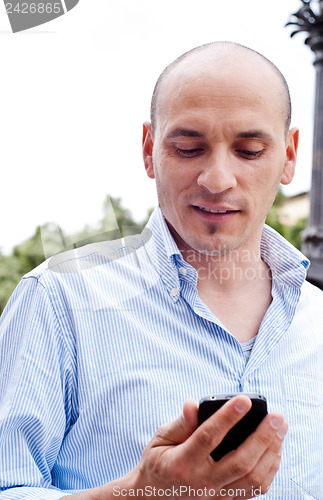 Image of businessman talking on cellphone outdoors