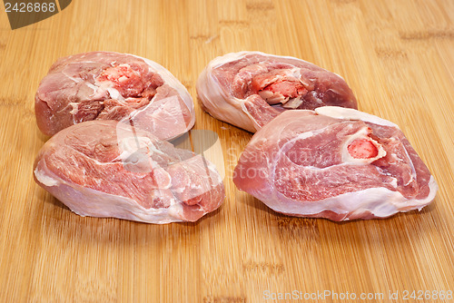 Image of raw ossobuco on wooden board