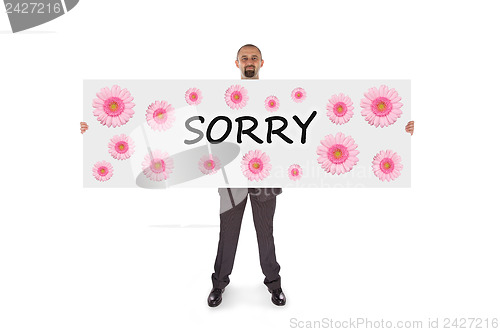 Image of Smiling businessman holding a really big card