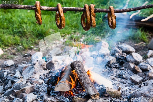 Image of Gernan brezels on a stick over fire