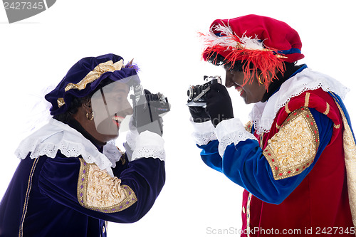 Image of Zwarte Piet and his co-worker are taking photographs