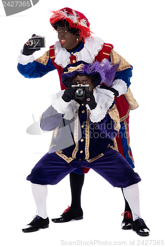 Image of Zwarte Piet and his co-worker are taking photographs