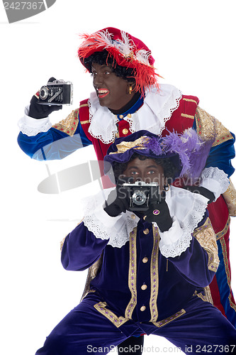 Image of Zwarte Piet and his co-worker are taking photographs