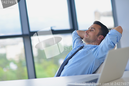 Image of happy young business man at office