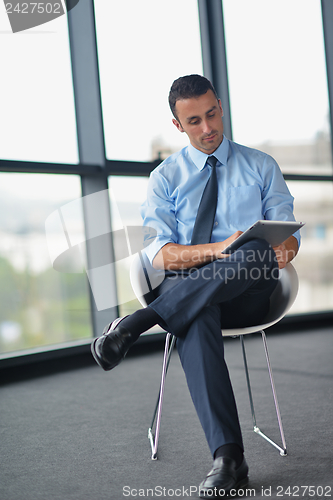 Image of happy young business man at office