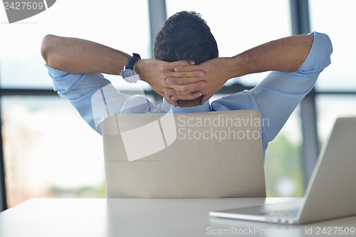 Image of happy young business man at office