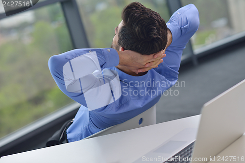 Image of happy young business man at office
