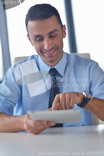 Image of business man using tablet compuer at office