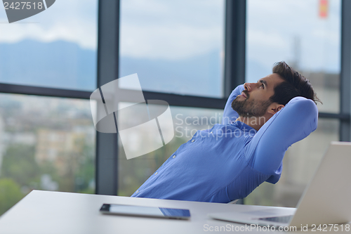 Image of happy young business man at office