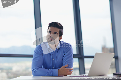 Image of happy young business man at office