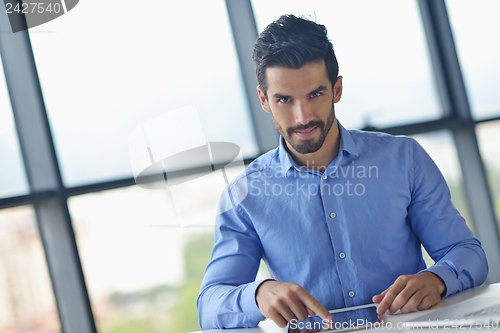 Image of business man using tablet compuer at office