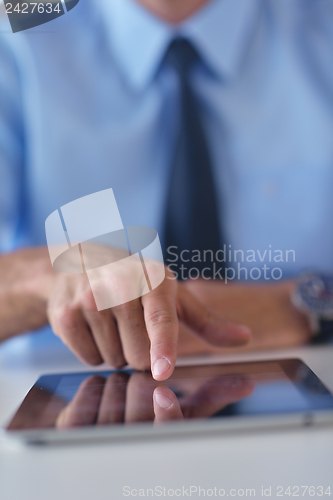 Image of business man using tablet compuer at office