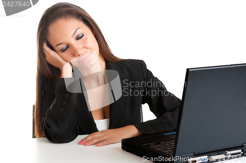 Image of Businesswoman Sitting at Her Desk Sleeping