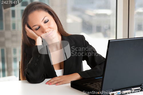 Image of Businesswoman Sitting at Her Desk Sleeping