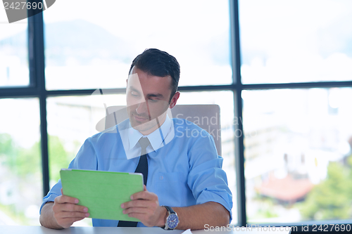 Image of business man using tablet compuer at office