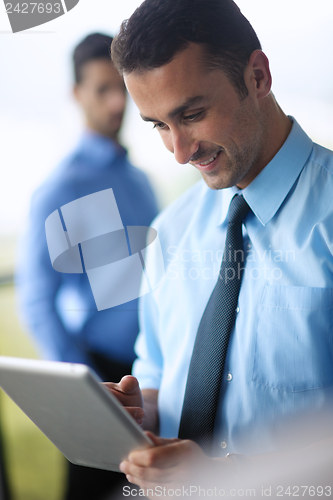 Image of business man using tablet compuer at office