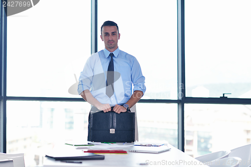 Image of business man waiting for meeting to begin in Board room